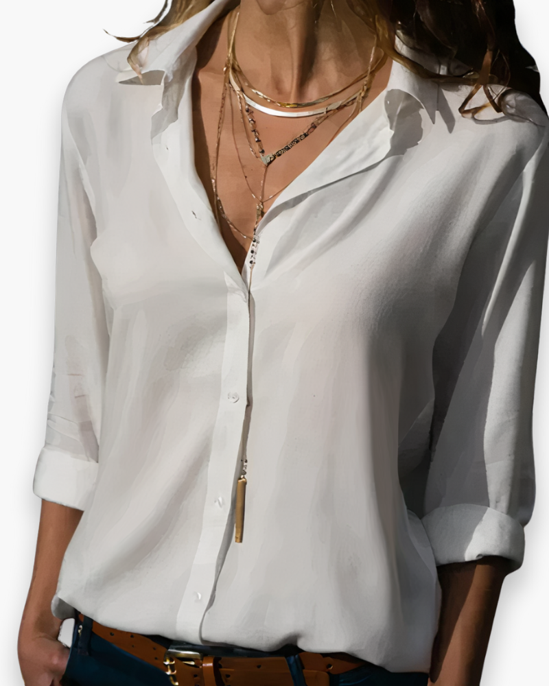 Elegancka biała bluzka damska z długim rękawem, szykowny krój, idealna do biura lub na wieczorne wyjście, dostępna w bieli i jasnym błękicie.