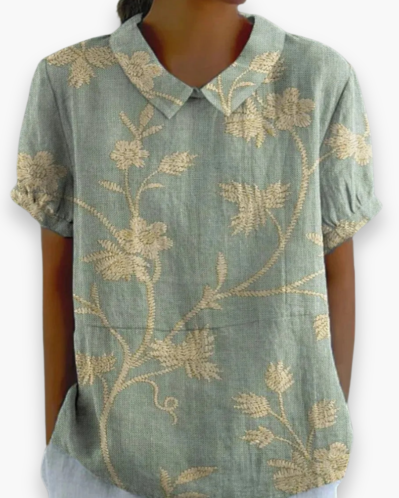 Luźna damska bluzka w kwiaty, widok z przodu, z kolorowym wzorem kwiatowym i lekkiej tkaniny, idealna na lato.