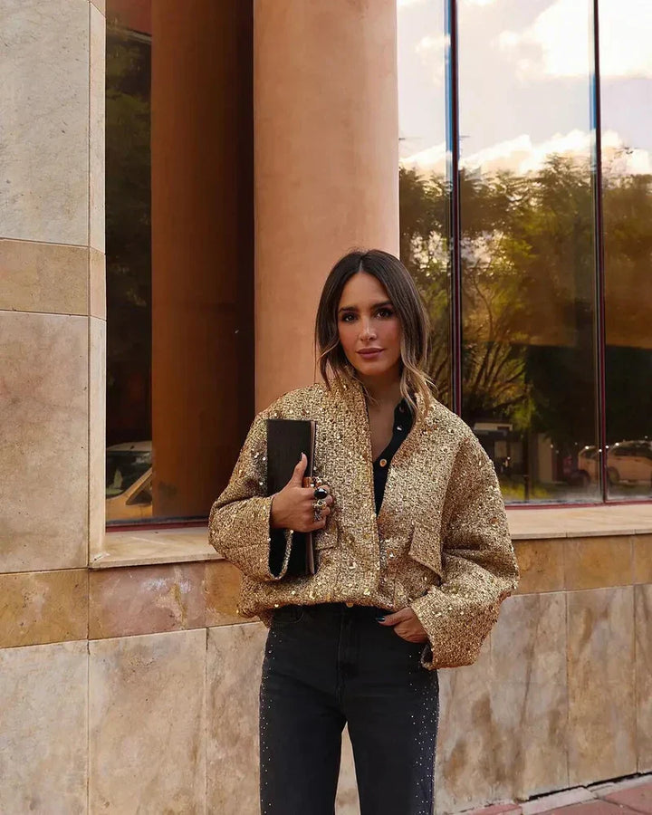 Damska kurtka bomberka z cekinami w kolorze złotym, szykowna i efektowna, z długimi rękawami, idealna na eleganckie wieczory.