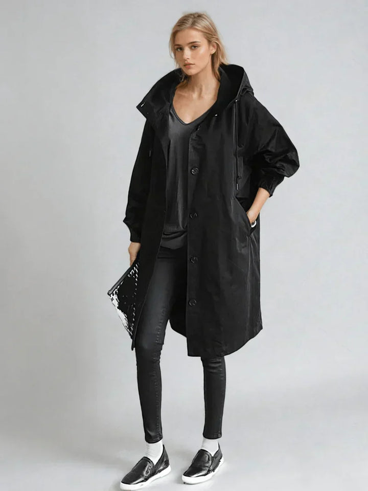 Kobieta w eleganckim, wodoodpornym płaszczu przeciwdeszczowym o klasycznym kroju. Modny płaszcz damski.