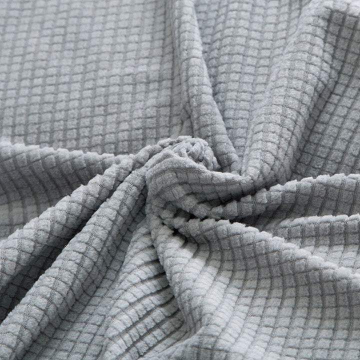 Housse de canapé extensible beige avec motif élégant et design antidérapant, disponible en plusieurs tailles pour salons mode