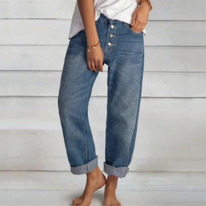 Damskie jeansy vintage z wysokim stanem i prostymi nogawkami, w kolorze niebieskiego denimu, z detalami w postaci wielu guzików z przodu.