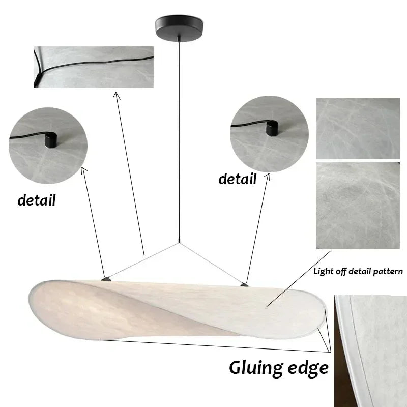 Designerski jedwabny abażur wiszący, o płynnych i eleganckich kształtach, tworzący miękkie światło dla szykownego i kojącego wnętrza.