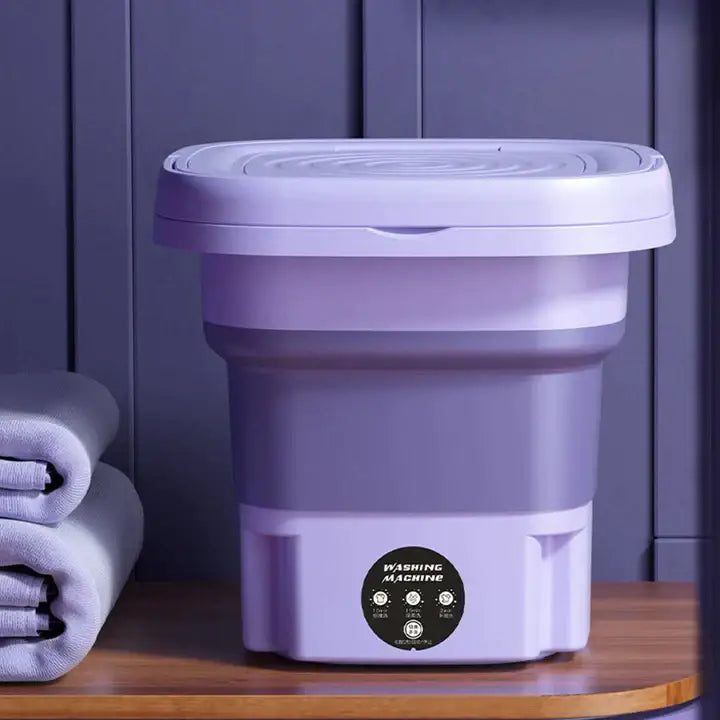 Fioletowa przenośna mini pralka, kompaktowa i składana, nowoczesny design, efektywne pranie i łatwy transport.