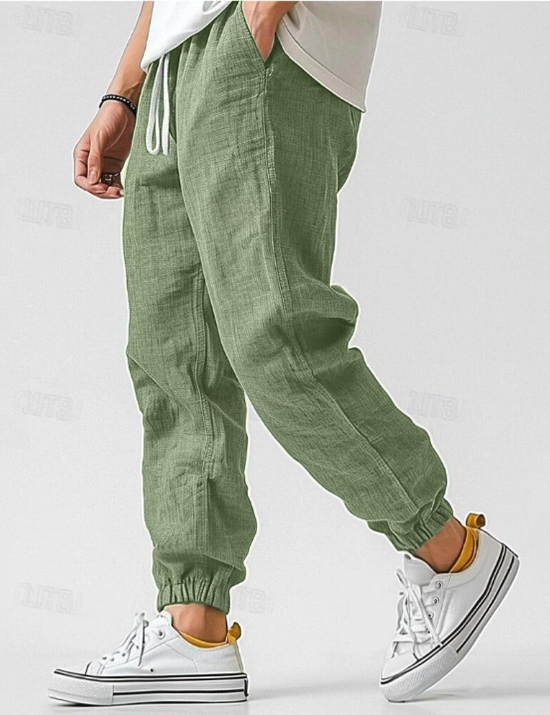 Męskie niebieskie spodnie lniane, lekkie i oddychające, w stylu casual na lato, zapewniające komfort i elegancję.