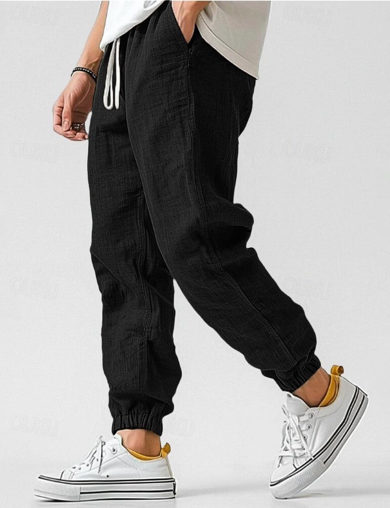 Męskie czarne spodnie lniane, lekkie i oddychające, w stylu casual na lato, zapewniające komfort i elegancję.