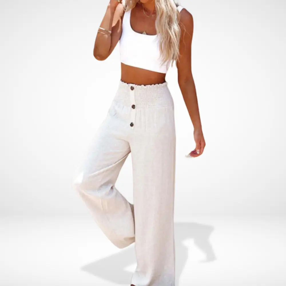 Szerokie spodnie damskie z marszczoną talią, detale z guzikami, płynny i elegancki krój, nowoczesny i wygodny styl.