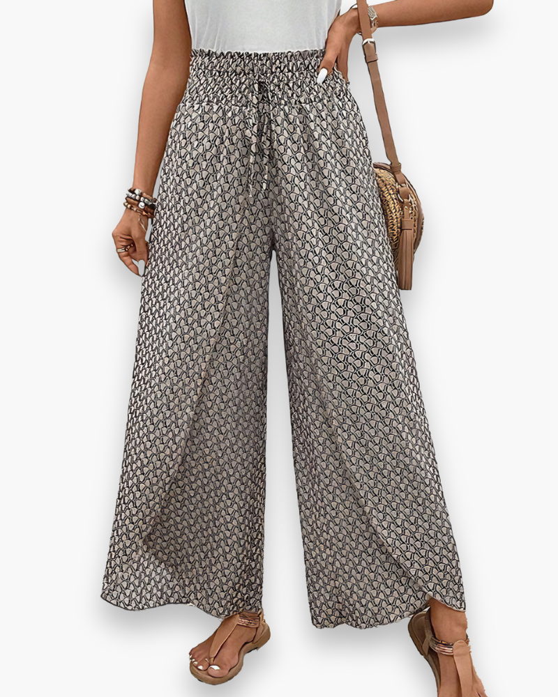 Szerokie spodnie damskie, luźny krój, nowoczesny graficzny wzór, elastyczna talia, szykowny i wygodny styl, widok z przodu.