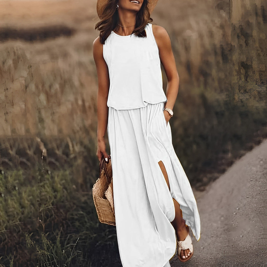 Elegancka i kolorowa sukienka maxi JONNA bez rękawów, w stylu retro, z lekkiego i zwiewnego materiału, zapewniająca wyrafinowany wygląd.