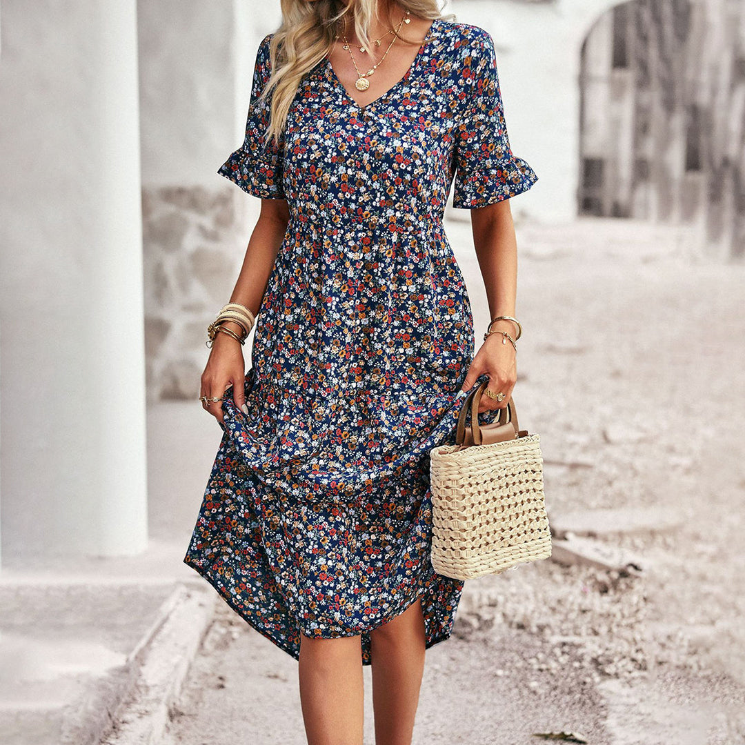 Elegancka kwiecista sukienka midi dla kobiet, kwiatowy wzór, czarna, korzystny krój, uniwersalna na każdą okazję.