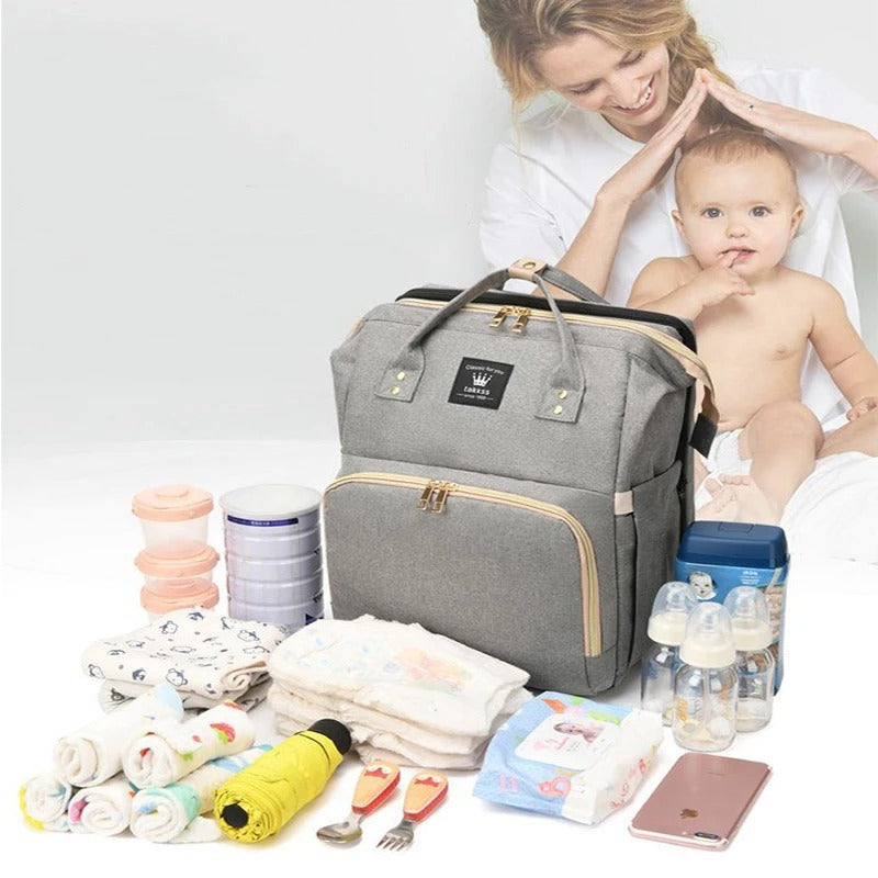 Stylowa i ergonomiczna torba na pieluchy 3 w 1 z wbudowanym łóżeczkiem, regulowanymi szelkami i wieloma przegródkami, kolor szary.