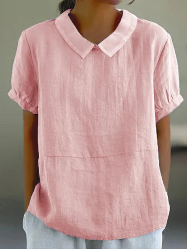 Widok z przodu eleganckiego jednolitego topu bawełniano-lnianego dla kobiet, podkreślający jego elegancję i komfort.